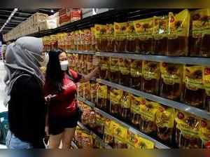 FILE PHOTO: People shop for cooking oil made using palm oil at a supermarket in Jakart
