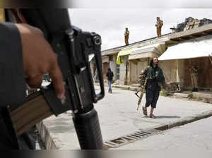 Kabul: Taliban fighters stand guard at the site of an explosion in front of a sc...