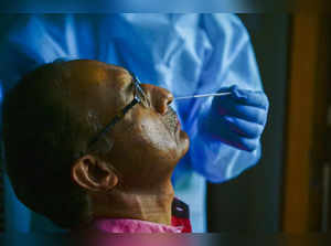 New Delhi: A healthworker conducts COVID-19 tests at a school in New Delhi. (PTI...