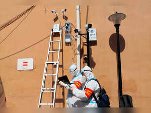 Workers set up surveillance cameras following COVID-19 cases in Mudanjiang