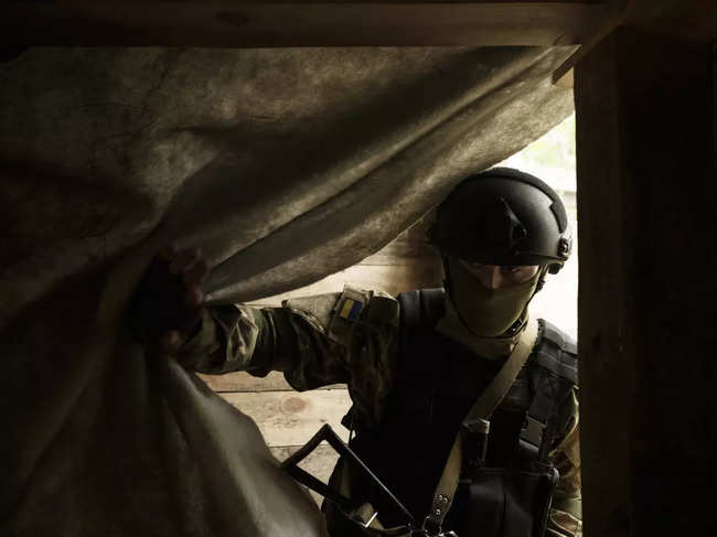 A Ukrainian National Guard soldier enters a underground shelter at a position near Kharkiv, Ukraine, Monday, May 9, 2022. (AP Photo/Felipe Dana)