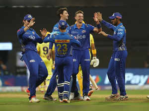 Mumbai: Daniel Sams of Mumbai Indians celebrates with teammates, the wicket of R...