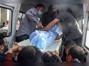 Srinagar: Medical staff carry the body of Kashmiri Pandit Rahul Bhat, who was sh...