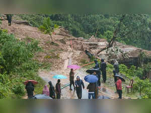 Dima Hasao: People stand near a landslide hit area following a heavy rainfall in...