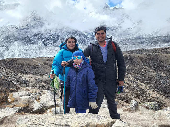 Rhythm Mamania poses with her parents in front of the Everest peaks.​