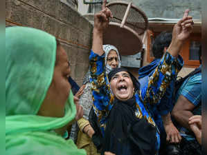 Srinagar: Relatives and neighbours of JKLF chief Mohammad Yasin Malik shout slog...