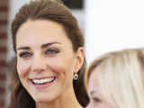 Catherine, Duchess of Cambridge, smiles as she meets actress Reese Witherspoon