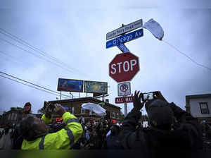 A new George Perry Floyd Square sign is unveiled in front of hundreds of communi...