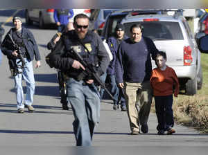 FILE- In this Dec. 14, 2012, file photo, parents leave a staging area after bein...