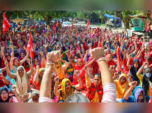ASHA workers, Anganwadi workers and mid-day meal workers raise slogans...