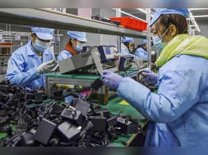 China's factory activity falls at slower pace on easing curbs - Caixin PMI