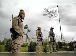 Kabul : Taliban special forces stand guard in front of the Taliban flag at a par...
