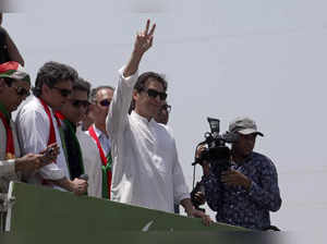 Ousted Pakistani Prime Minister Imran Khan gives the victory sign to supporters ...