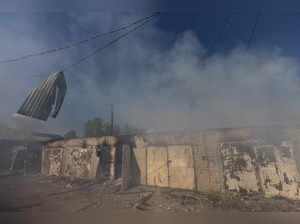 FILE PHOTO: A garage burns following a military strike on a garage near the railway station, amid Russia's invasion of Ukraine, in the frontline city of Lyman, Donetsk region