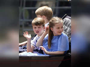 Prince George, left, Prince Louis and Princess Charlotte ride in a carriage as t...