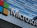 Microsoft warns of forex hit, cuts forecast