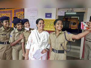 Kochi: Student police cadets take selfies with UDF candidate Uma Thomas at a pol...