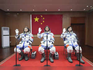 In this photo released by Xinhua News Agency, from left Chinese astronauts Cai X...