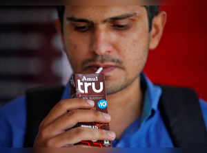 A man consumes Amul's chocolate flavoured drink outside an Amul cafe in Ahmedabad