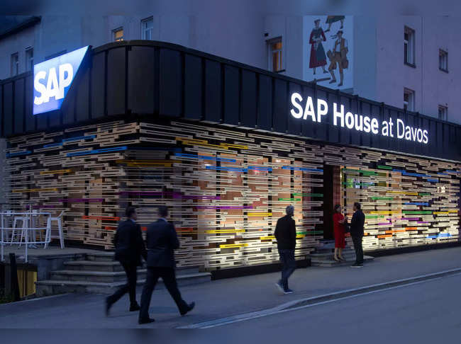 People walk past the temporary office of SAP in Davos