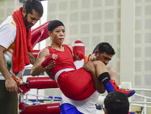 New Delhi: Boxer Mary Kom being taken out of the boxing ring after getting injur...