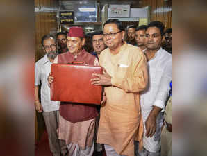 Dehradun: Uttarakhand Finance Minister Prem Chand Aggrawal with Chief Minister P...