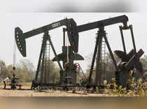 FILE PHOTO: A worker examines the valve of a pump on an ONGC well on the western Indian city of Ahmedabad