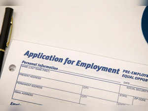 An employment application form is displayed during a restaurant job career fair in New York