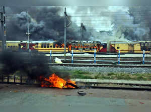 Patna: A train set on fire by a crowd in protest against the Centre's Agnipath s...