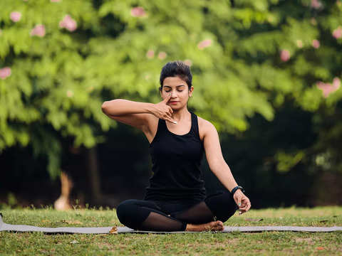 Beautiful Indian woman in yoga pose Stock Photo | Adobe Stock