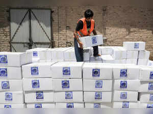 A volunteer from the Al-Khidmat Foundation arranges food boxes to send for the people affected by the earthquake in Afghanistan, in Peshawar