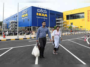Shoppers walk outside IKEA's new store in Bengaluru