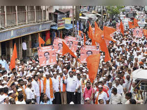 Kolhapur: Shiv Sena workers take part in a protest rally against rebel Shiv Sena...