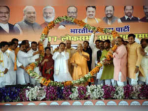 Rampur: Uttar Pradesh Chief Minister Yogi Adityanath being garlanded during an e...