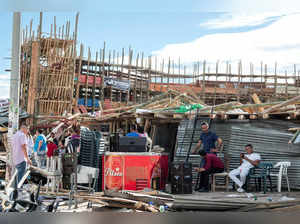 Residents gather near the rubble of some stands that collapsed in a bullring during the celebrations of the San Pedro festivities, in El Espinal