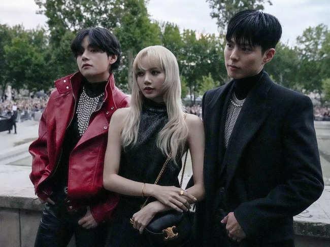 (L_R) ​V, Lisa, and Park Bo-gum pose for photographers before the Celine men's Spring Summer 2023 collection presented in Paris, France.