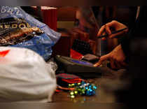 FILE PHOTO: A customer signs the credit card pad as he pays for a purchase at Macy's on Black Friday in New York