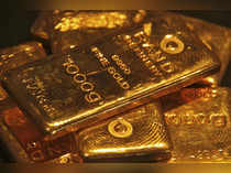 Gold inches down as U.S. bond yields bounce back