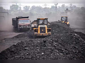 Ranchi: Labourers carry coal onto goods train at Ashoka Coal Mines in Peeparwar,...
