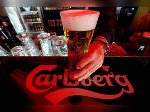 FILE PHOTO: FILE PHOTO: A bartender holds a glass of Carlsberg beer in a bar in St. Petersburg