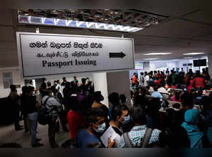 Sri Lankans gather outside the Immigration and Emigration Department to get their passports to leave the country amid the country's economic crisis