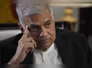 FILE- Sri Lanka's new prime minister Ranil Wickremesinghe gestures during an int...
