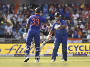 India's Hardik Pandya, left, and India's Rishabh Pant, touch gloves during the t...