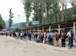 Pahalgam, July 10 (ANI): Amarnath pilgrims wait in a queue to enter Baltal base ...