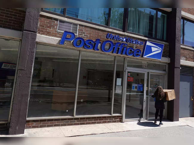A person enters a United States Postal Service Post Office in Manhattan, New York City
