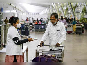 Health worker conducts thermal screening of a passenger