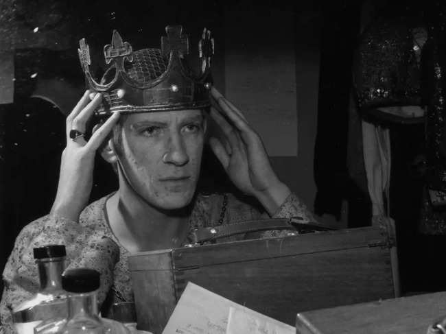 ​ David Warner of the Royal Shakespeare Company trying on a crown in his dressing room​.