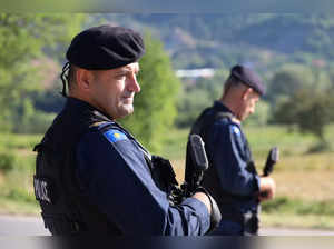 Kosovo police patrol a road in Zupce