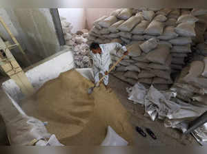 A worker loads rice after collection from a field in the rice mill  in Najaf