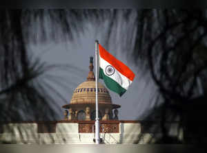 An Indian national flag flutters on top of the Indian parliament building in New Delhi